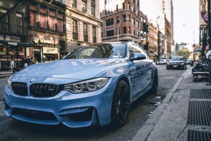 blue BMW coupe parked on the road during daytime
