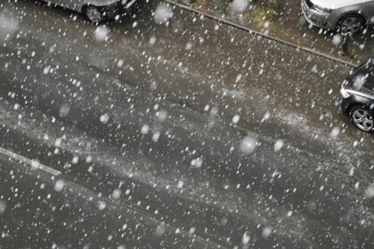 two cars parked on the side of the road in the snow