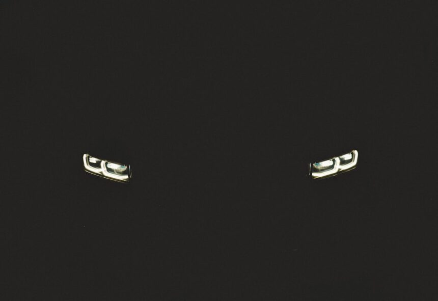 a pair of silver cufflinks on a black background