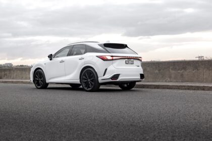 A white lexus suv is parked on the side of the road