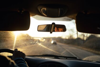 a person driving a car on a highway