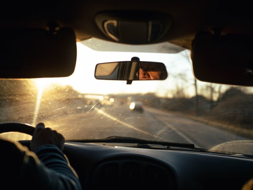 a person driving a car on a highway