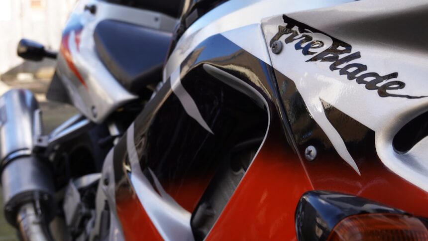 Close-up of a red and white motorcycle with fireblade text