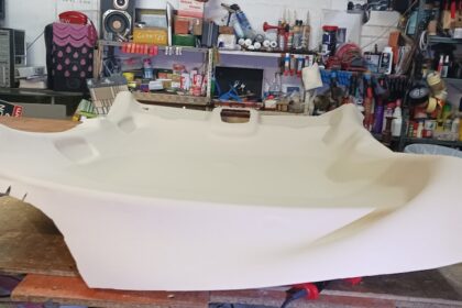 a large white boat being made in a shop
