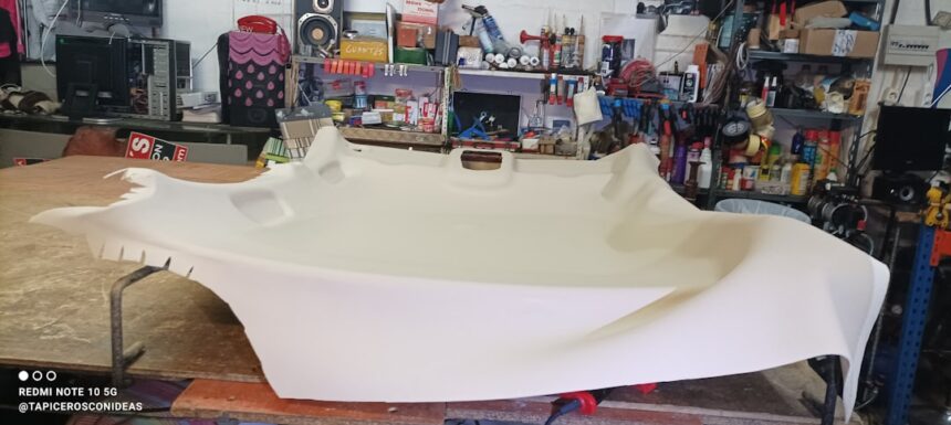 a large white boat being made in a shop
