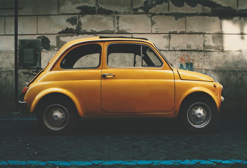 a small yellow car parked in front of a building