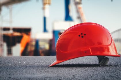red hard hat on pavement