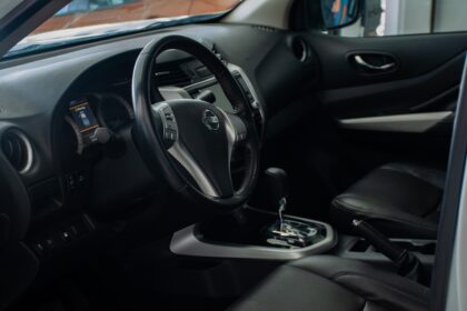 the interior of a car with a steering wheel and dashboard