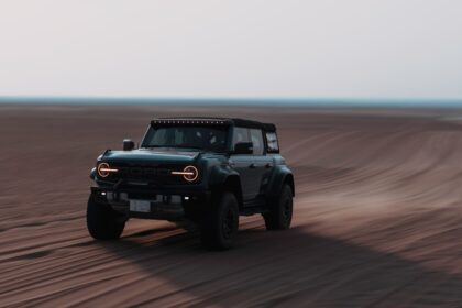 A jeep driving through the desert on a clear day