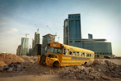 a yellow bus parked in a city