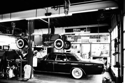 a black and white photo of a car in a garage