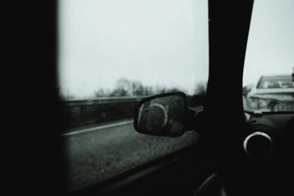 a rear view mirror of a car on a road