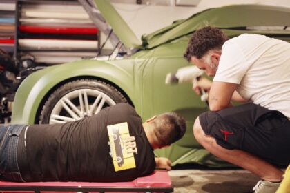 a man is working on a car in a garage