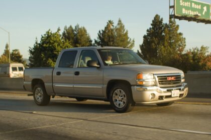 Silver pickup truck driving on a highway