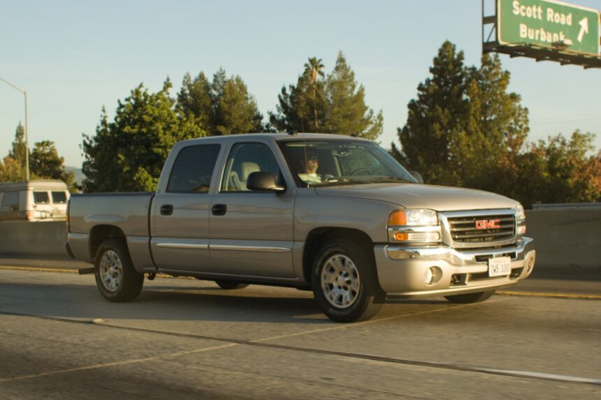 Silver pickup truck driving on a highway
