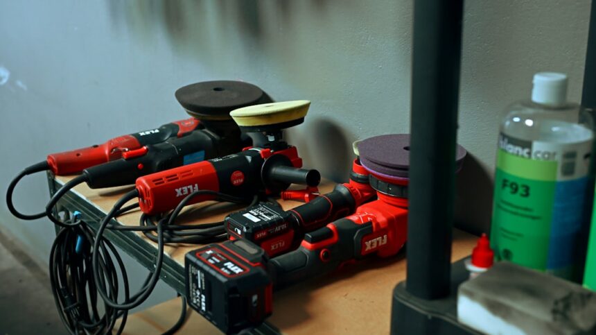 Several red car polishing tools on a shelf