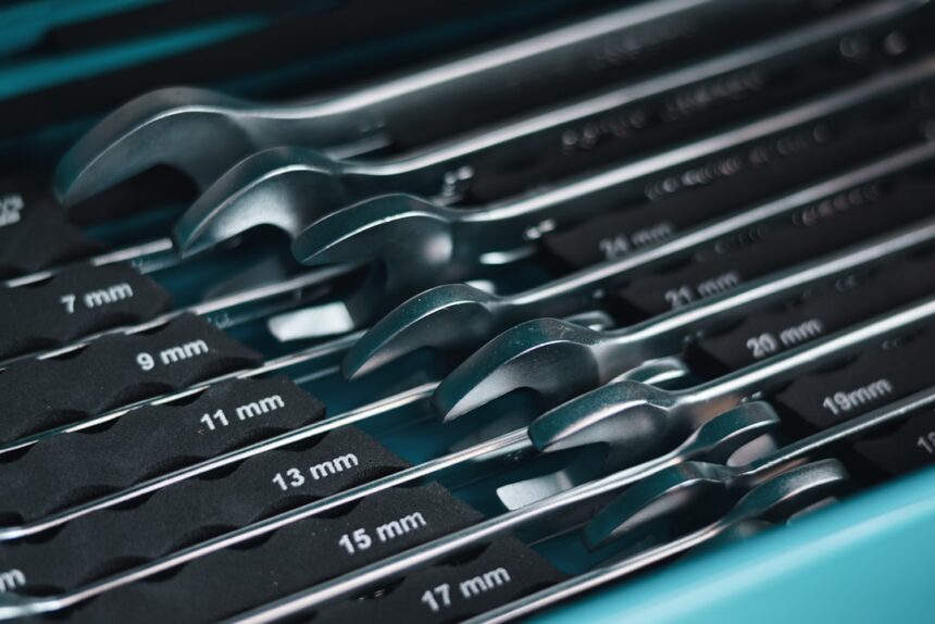 A set of metal wrenches in a toolbox
