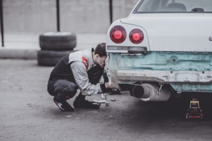 man fixing car