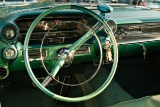A green car with a steering wheel and dashboard