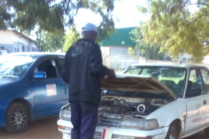 Auto mechanic technician fixing a malfunctioning car.jpg