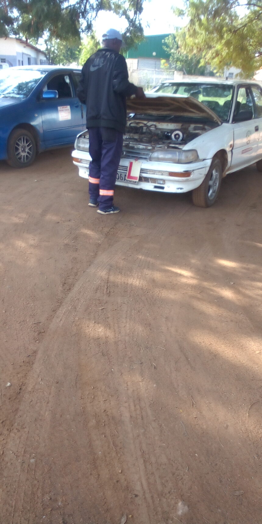 Auto mechanic technician fixing a malfunctioning car.jpg