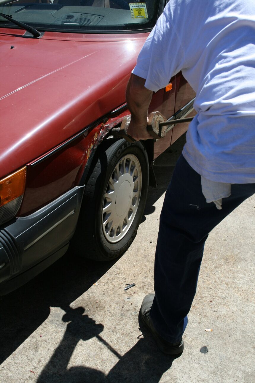 2008-08-11 Mechanic straightening fender.jpg