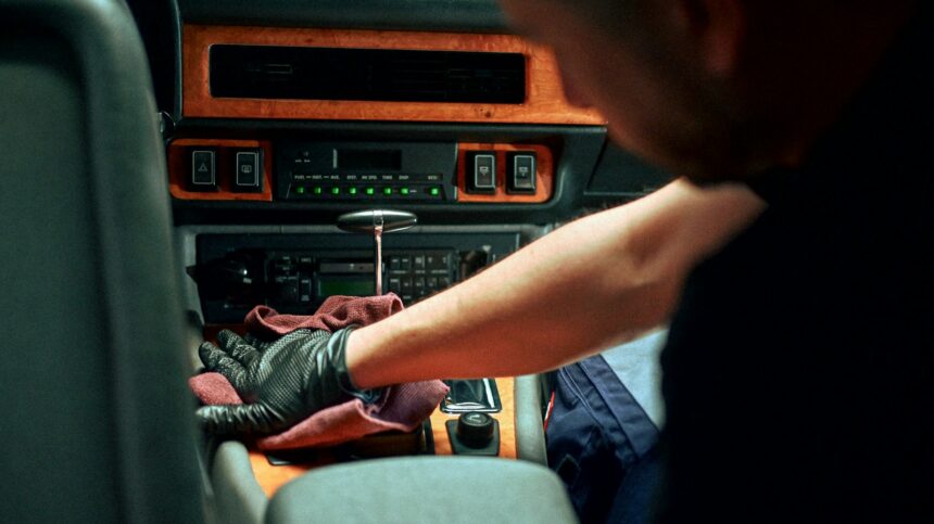 Detailer cleaning a car interior dashboard and console