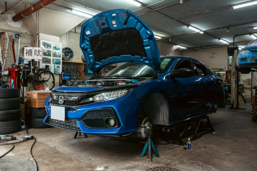 Car raised on a workshop lift with the underbody exposed