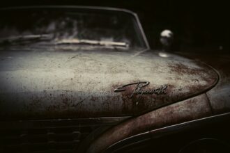 Sun-faded and oxidised paint on a car hood