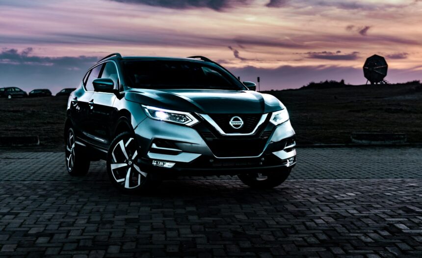 Blue Nissan Rogue crossover photographed at sunset